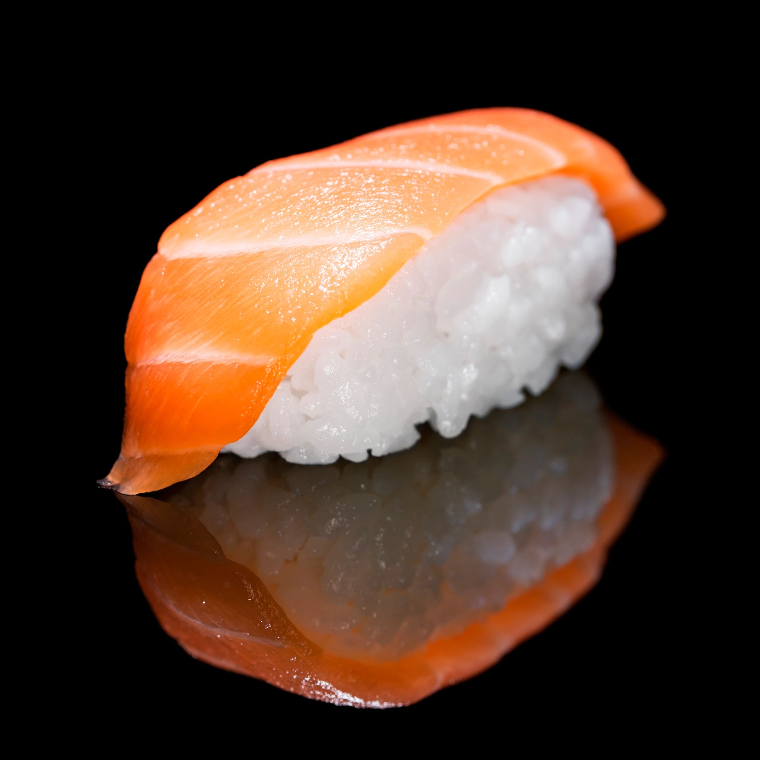 Salmon sushi on dark background